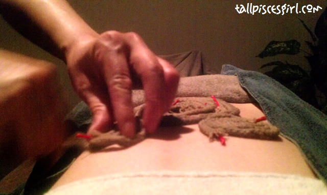 Putting strings that has been soaked with Tibetan herbs onto my stomach