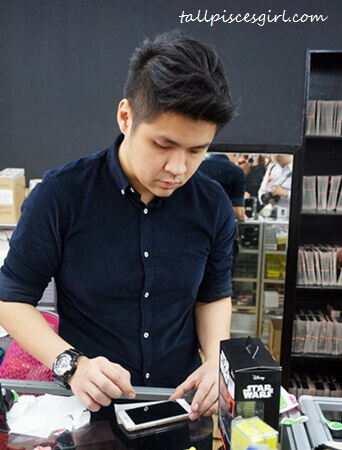 Max carefully helping us to stick tempered glass protector