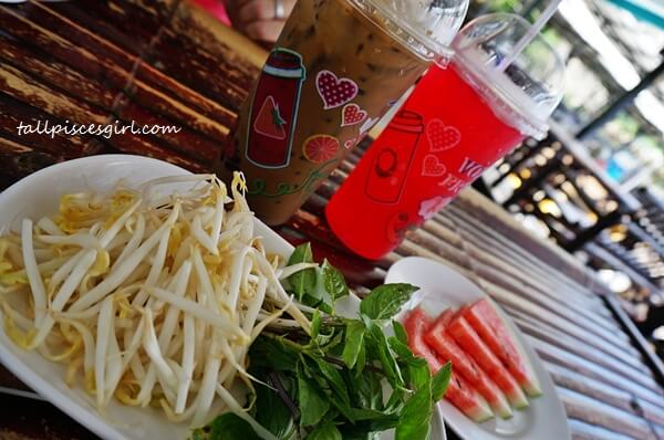 DSC00224 | What to Eat in Krabi: Ao Nang Boat Noodle Our drinks, raw bean sprouts, leaves and complimentary watermelons