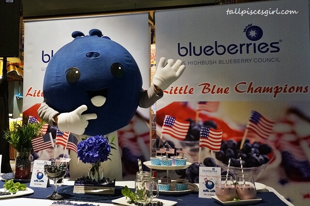 US Highbush Blueberries - The Little Blue Champion mascot