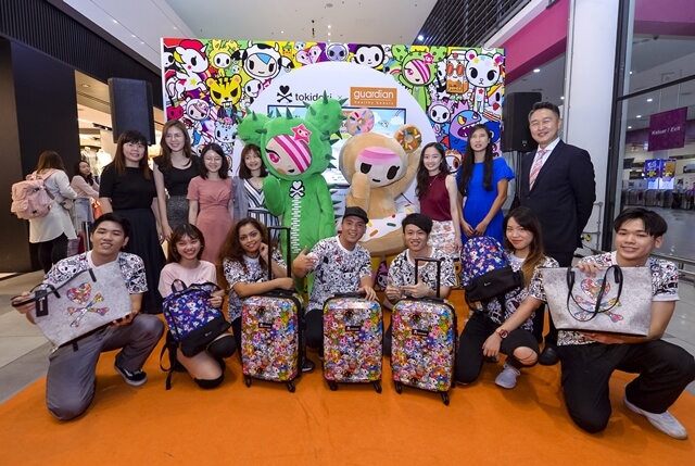 Group Photo | Guardian Exclusive tokidoki Travel Series Christine Chew, Channel Head from Nutox, Vean Fong, Key Account Manager from Nutox, Steph Teoh, Customer Development Manager from Dove, Hiap Yi San, Senior Key Account Executive from Ensure Gold, Siew Yann Lin, Key Account Manager from Pantene, Jaynie Lai, Group Customer Development Manager from Blackmores, and DY Cho, Marketing Director, Health and Beauty, South East Asia, Guardian Health And Beauty Sdn Bhd striking a photo with tokidoki dancers and the Guardian Exclusive tokidoki Travel Series at the launch event