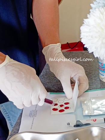 Dripping my blood onto the Blood Collection Card | Speedoc Telemedicine App X Allergy Test Review Dripping my blood onto the Blood Collection Card